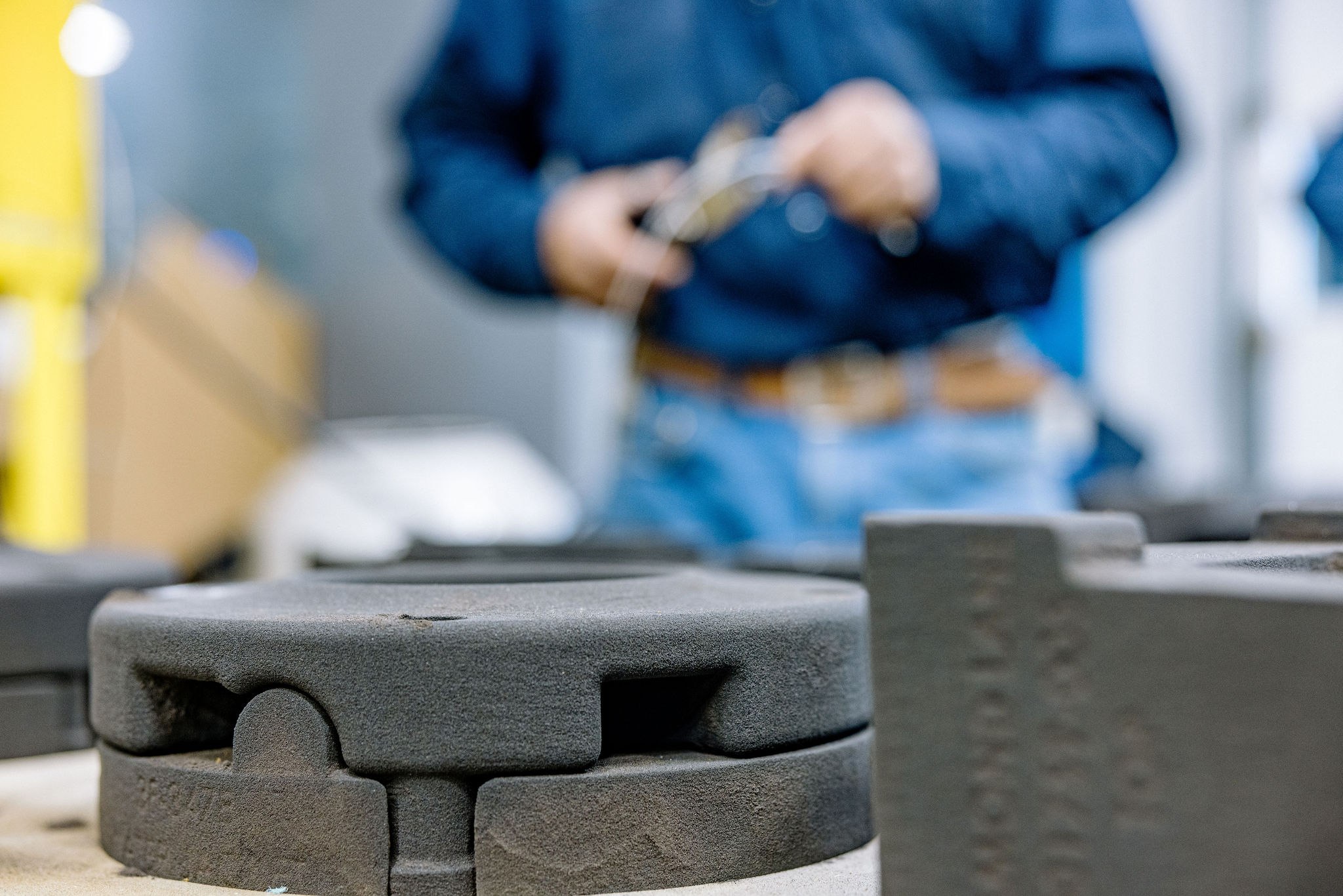 Detail view of a 3D-printed sand mold on the shop floor — the same patternless workflow supports both carbon steel and stainless valve body pours on 1-to-100-piece runs.